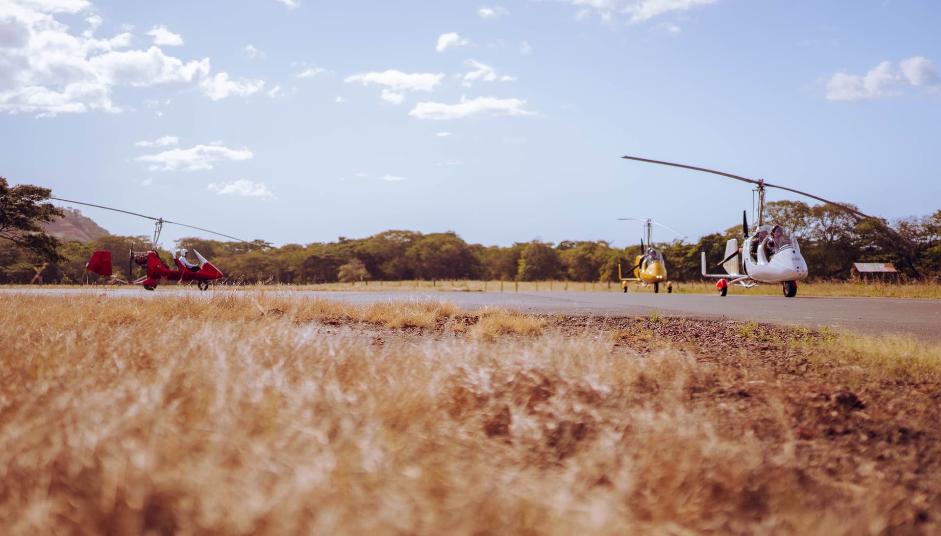 Open-cockpit gyrocopter over the Guanacaste coast, Costa Rica